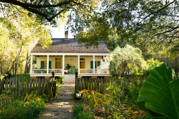 Exterior of Maison Madeleine B&B, authentic 1840 French Creole cottage nestled under trees located on the edge of Lake Martin cypress swamp, Breaux Bridge, Louisiana, USA