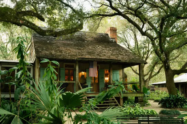 Exterior of Maison Madeleine B&B, authentic 1840 French Creole cottage nestled under trees located on the edge of Lake Martin cypress swamp, Breaux Bridge, Louisiana, USA