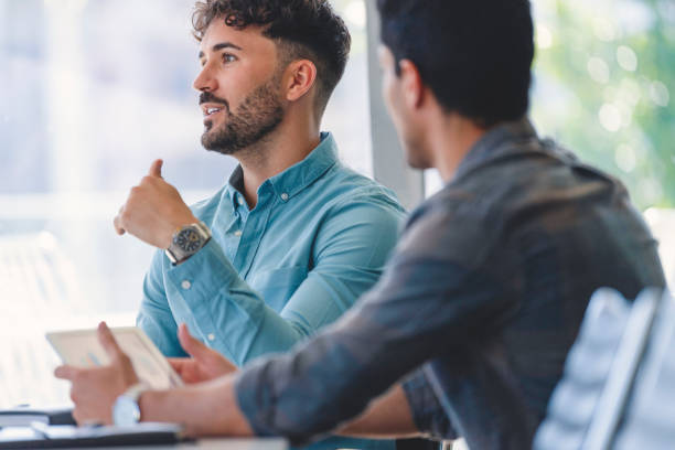 istock Two businessmen meeting. One man is talking and explains something with gestures. 1327161159
