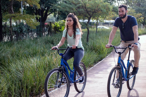 istock Couple at a public park biking 1327164595
