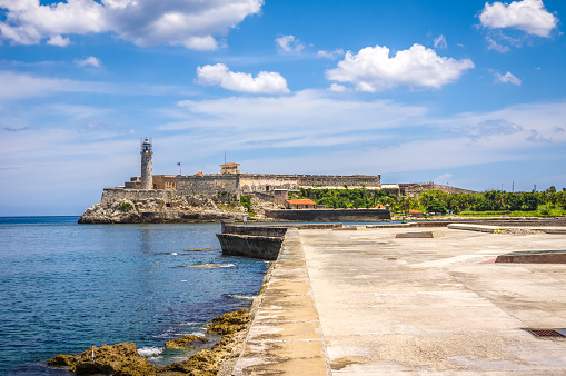 El Morro Spanish fortress and lighthouse in a cloudy day from El Malecon in La Habana. Cuba