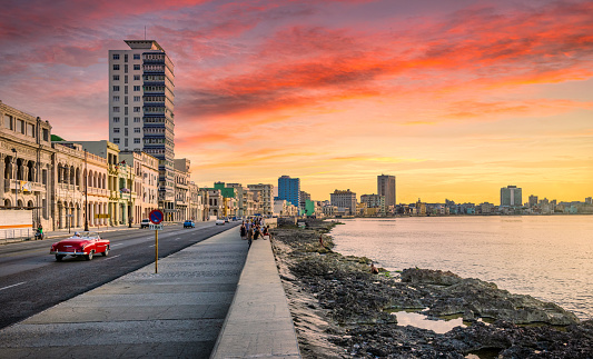 EL Malecon (Avenida de Maceo) at sunset, a broad landmark esplanade that stretches for 8 km along the coast in Havana past major city tourist attractions