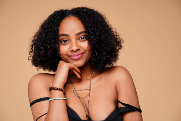 istock Happy smiling afro woman looking at camera, posing on beige studio background. 1327171768