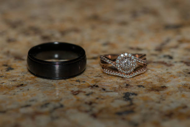 istock Bride and groom wedding rings on granite surface 1327176479
