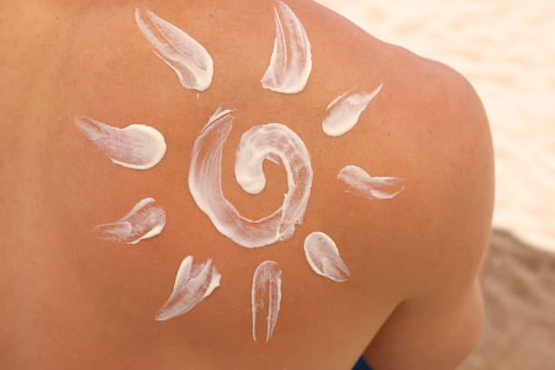istock Sun is painted on man back with white sunscreen closeup 1327181466