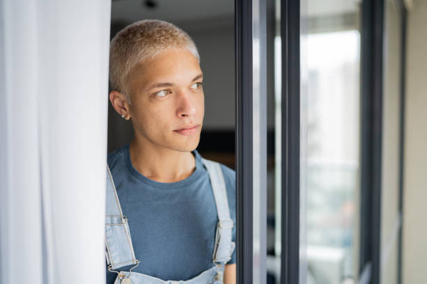 istock Young man contemplating at home 1327181971