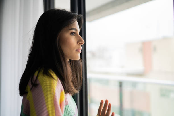 istock Young woman contemplating at home 1327182006