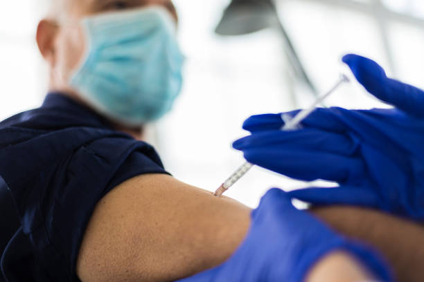 istock A senior doctor vaccinates a young female patient 1327182343