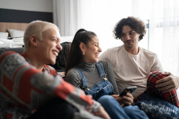 istock Friends using smartphone and talking at home 1327182475