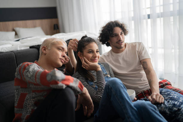 istock Friends watching tv together at home 1327182573