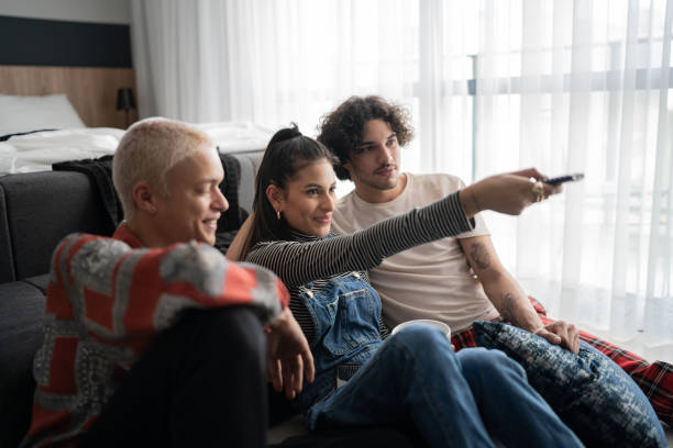 istock Friends watching tv together at home 1327182577