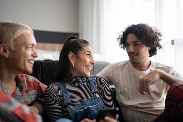 istock Friends using smartphone and talking at home 1327182579
