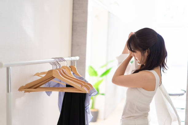 istock Young woman changing clothes in her room 1327187457