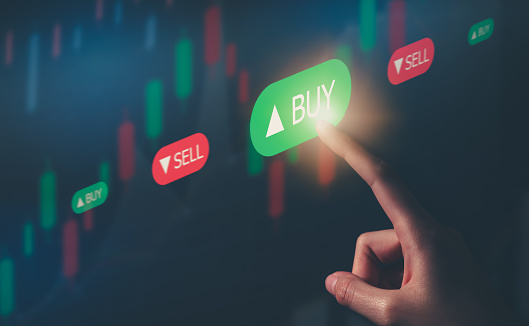 Stock exchange market concept, hand touching on trading icon screen with graphs analysis candle line on bokeh colors light.