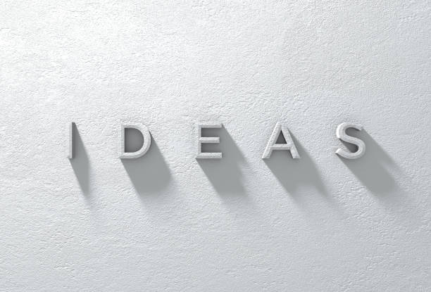 istock Textured White Stucco Wall IDEAS Sign with Long Shadow 1327196791
