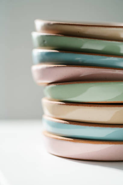 istock A large stack of ceramic cups in pastel colors. 1327197738