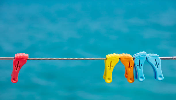 istock Clothespins on empty clothes line. Blur blue color background. 1327198370