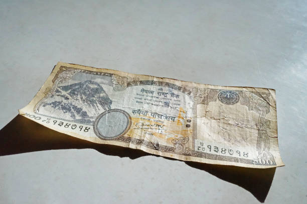 istock Close up Nepali Rupee banknotes on white table 1327203197