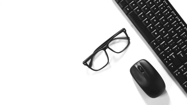 istock Pure white background view with mouse keyboard and glasses 1327203259