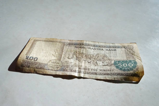 istock Close up Nepali Rupee banknotes on white table 1327203285