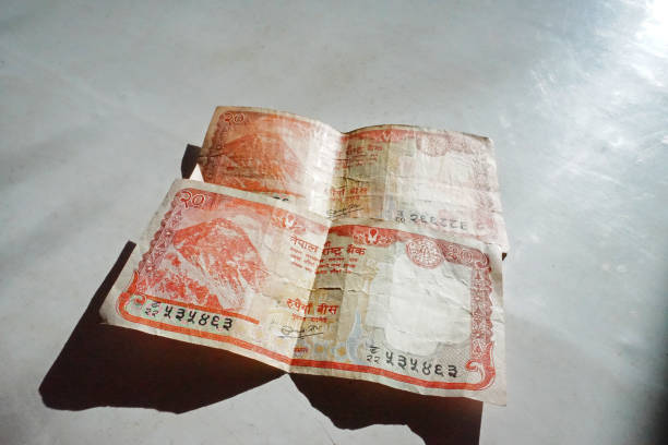 istock Close up Nepali Rupee banknotes on white table 1327203286