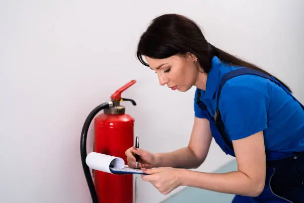 Safety Checking Fire Extinguisher. Emergency Prevention System