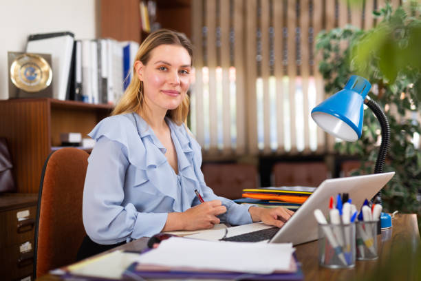 istock Successful businesswoman working with paperwork and laptop 1327207695