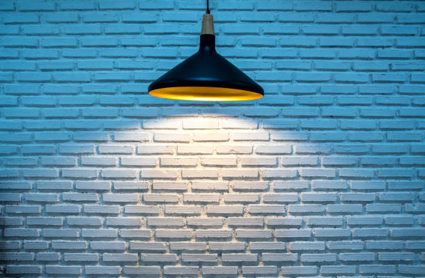 istock Hanging lamp and brick wall blue tone background 1327208968