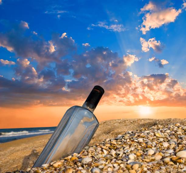 istock bottle on a sea coast at the sunset 1327211140