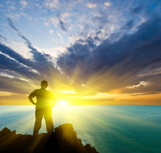 istock man stay on a sea cape at the sunset 1327211227