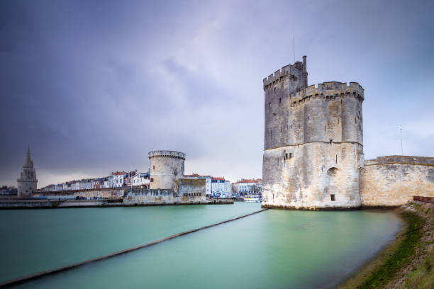 Storm over the entrance of the old harbor of La Rochelle in France, with the Tour de la Chaine on the left side and Tour Saint-Nicolas on the right side, Nouvelle Aquitaine region, department of Charente-Maritime, France. stock photo