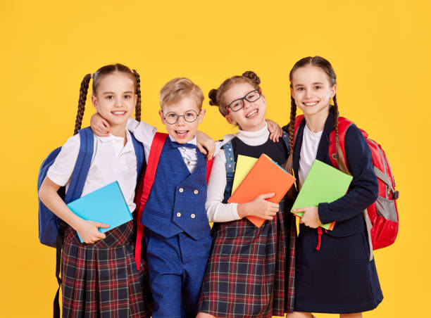 istock Group of happy schoolkids with backpacks 1327213352