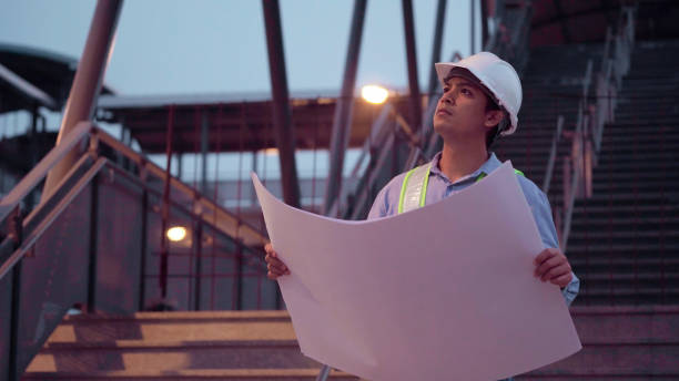istock Male engineer with hard hat looking and checking progress of Sky Train project. 1327214696