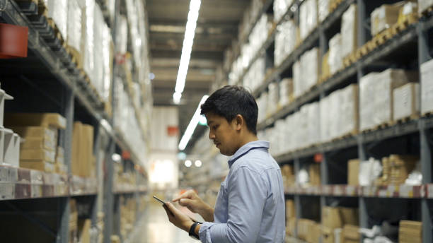 istock Man worker checking products with tablet in warehouse. 1327214750