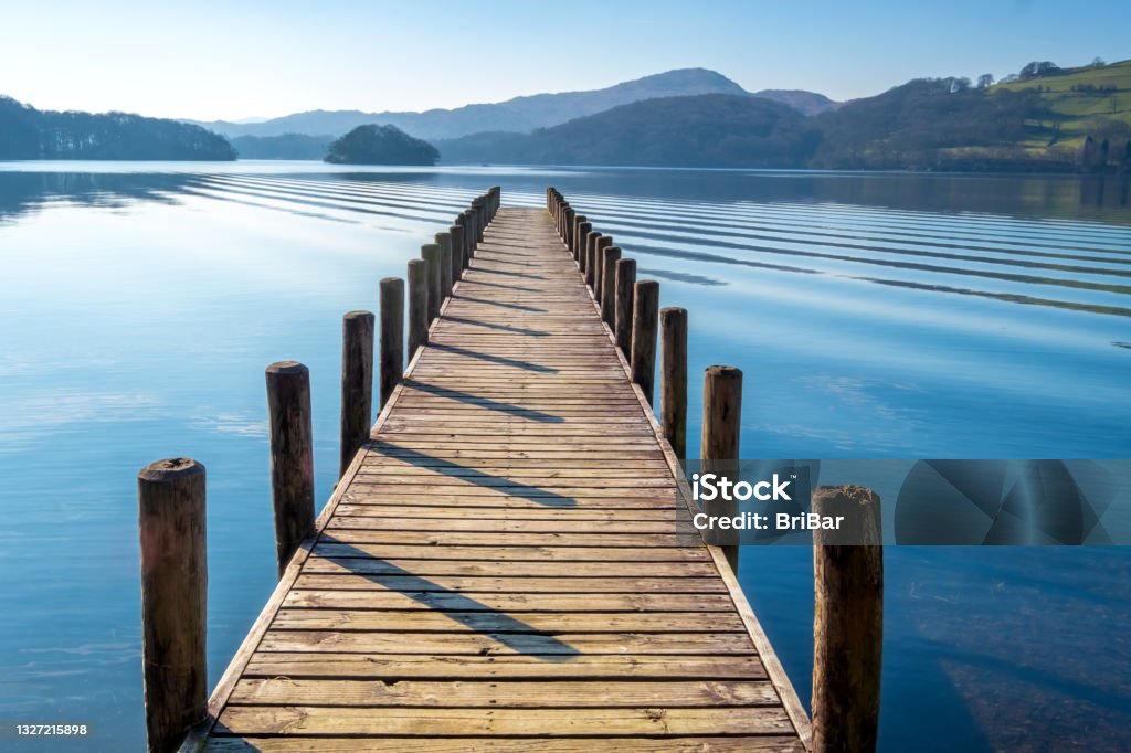 Landing Stage on Coniston Water, English Lake District, Cumbria, UK Wooden landing stage on Coniston Water. Jetty Stock Photo