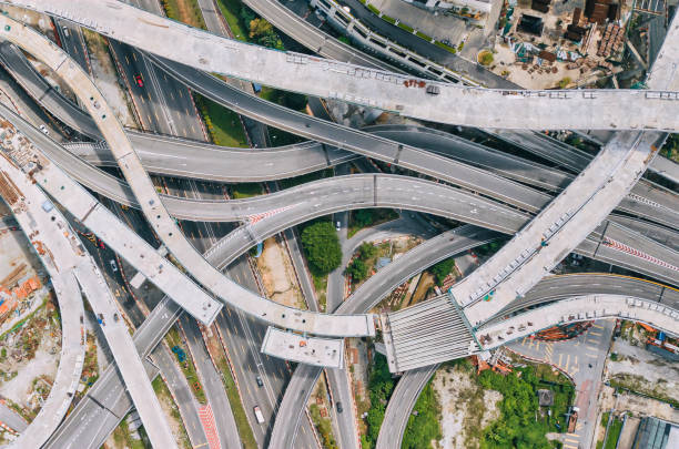 istock Drone view directly above city under construction with elevated road bridges cross junction 1327216193