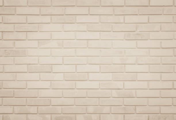 istock Empty Background of wide cream brick wall texture. Old brown brick wall concrete or stone pattern nature, wallpaper limestone abstract floor/Grid uneven interior rock. Home & office design backdrop. 1327217956