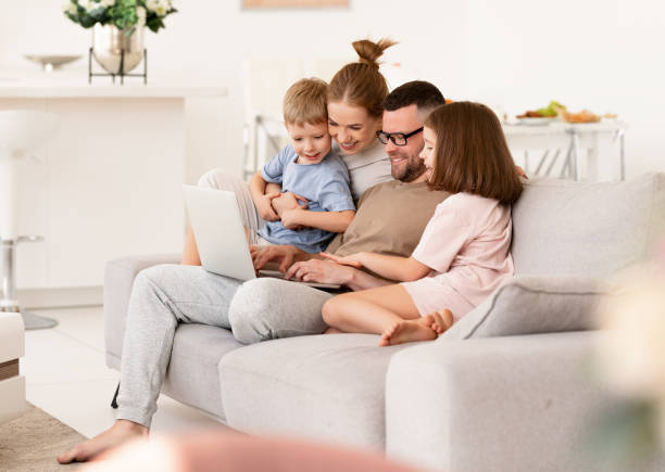 istock Young beautiful family using modern technologies while spending time together at home 1327218369