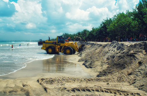 Bulldozer doing construction at beach in Bali