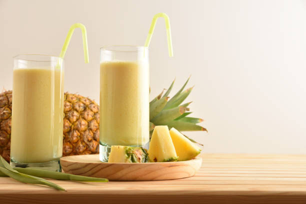istock Two tall glass glasses with pineapple juice isolated background. 1327220461