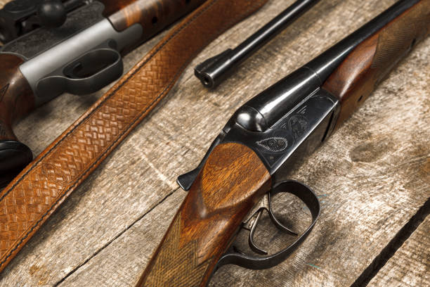 istock Many hunting rifles on weathered wooden surface 1327228801
