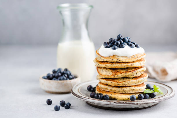 pancakes with poppy seeds, yogurt and blueberries - peach nectarine fruit portion imagens e fotografias de stock