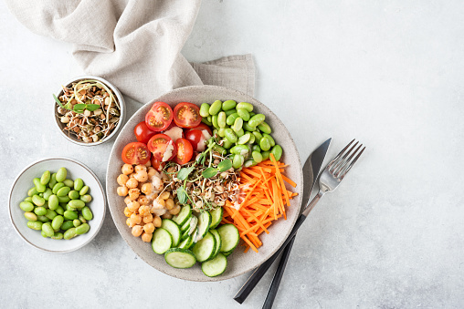 Vegan Salad Bowl With Chickpeas, Vegetables, Sprouts. Buddha Bowl On grey Concrete Background, Top view, Copy Space