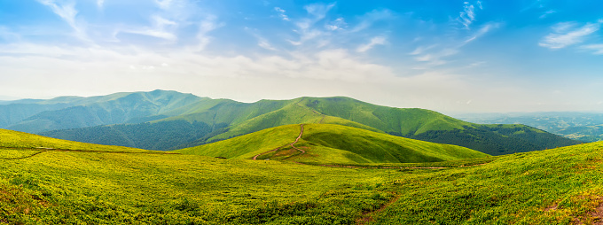 Carpathian mountains range Borzhava, green hills and blue sky, summer nature landscape, panoramic view.