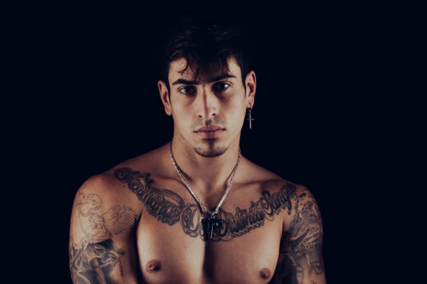 istock Man with tattoos and silver jewellery 1327230495