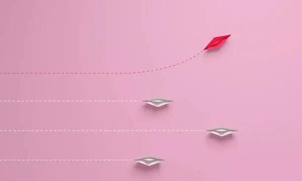 Women's disruption concept. Individual and unique leader pink paper ship changing direction on top view. 3d rendering.