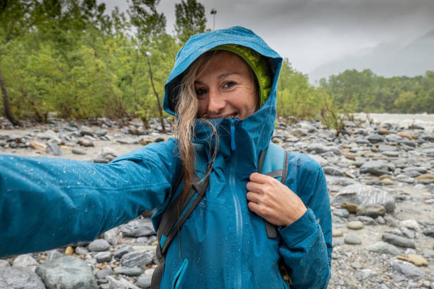 istock Hiker female under the rain take a selfie 1327231547