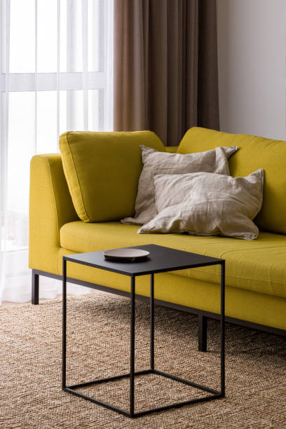 istock Stylish black coffee table and modern yellow couch 1327231560