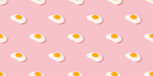 istock Seamless pattern of fried eggs on a pink background. 1327231590