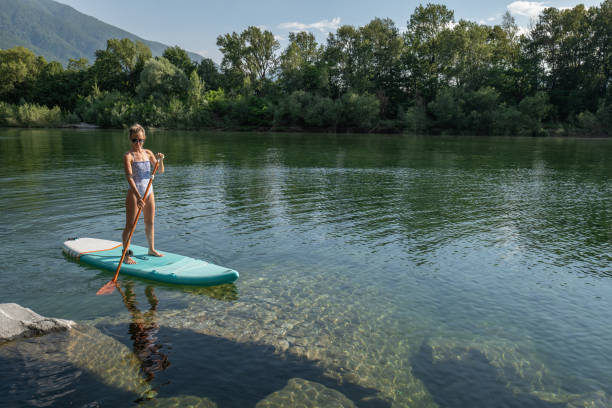 istock Woman paddling on a stand up paddle board 1327232396